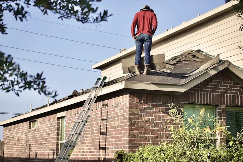 Professional roofer working on a residential roof in Old Severna Park